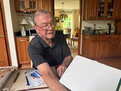 Bob-Kelly—reviewing-materials-from-his-service-in-Vietnam